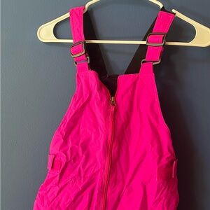 Bright pink Columbia snow bibs.